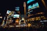 Neon-lit crossing in Shibuya, Tokyo at night